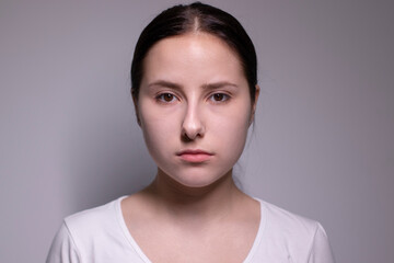 Fototapeta premium portrait of sad and depressed young woman. on gray background. nervous and upset people concept.