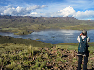 Naklejka premium Woman Observes the Birds in the Lagoon with Binoculars