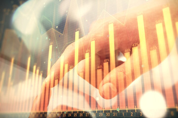 Multi exposure of man's hands holding and using a phone and financial chart drawing. Market analysis concept.