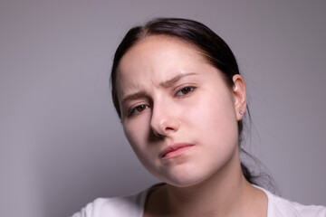 Fototapeta premium portrait of sad and depressed young woman. on gray background. nervous and upset people concept.