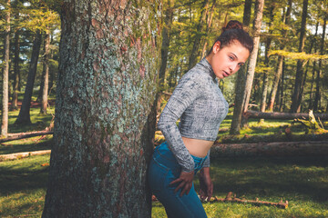 Young caucasian girl posing at the basque forest.