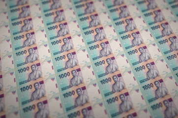 1000 Indonesian rupiah bills printed in illegal money production conveyor. Collage of many fake...