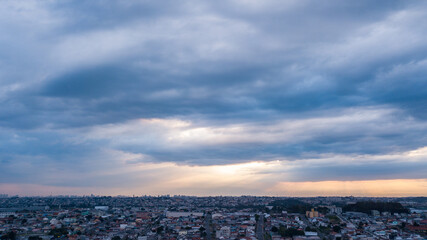 Sunset with clouds, in the background on the left side the city of Curitiba, capital of paraná, in an image taken with a drone in Pinhais, in the Metropolitan Region of Curitiba, Paraná