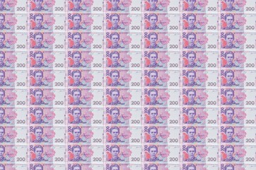 200 Ukrainian hryvnias bills printed in money production conveyor. Collage of many bills. Concept...