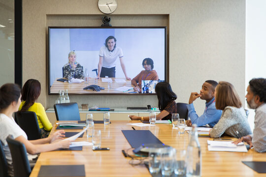 Business people video conferencing in conference room