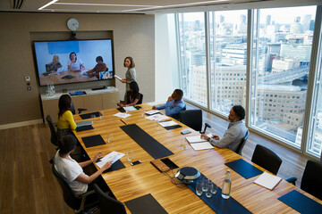 Business people video conferencing in conference room meeting