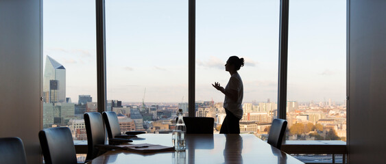 Businesswoman preparing for meeting in highrise conference room
