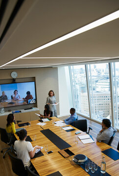 Business people video conferencing in conference room meeting