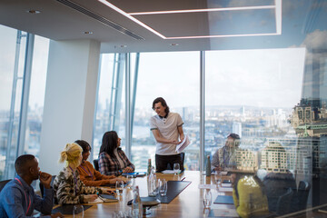 Businessman leading conference room meeting in highrise office
