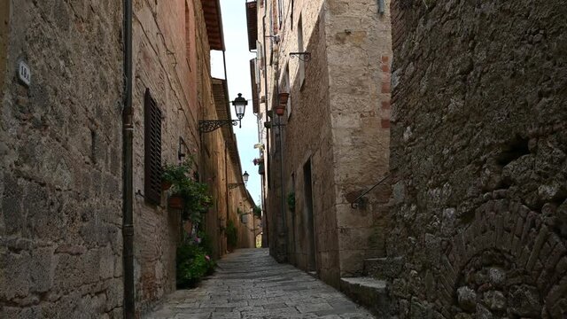 Colle di Val d'Elsa, Tuscany, Italy. August 2020. POV film walking in the alleys of the historic center: enchanting glimpses of medieval times full of charm, you advance along the paving.
