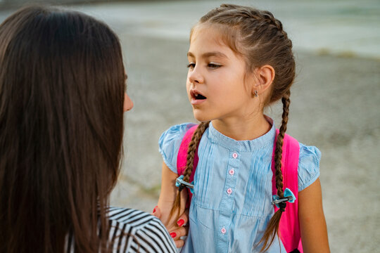 Cute Girl With School Bag Talking To Her Mother About School 