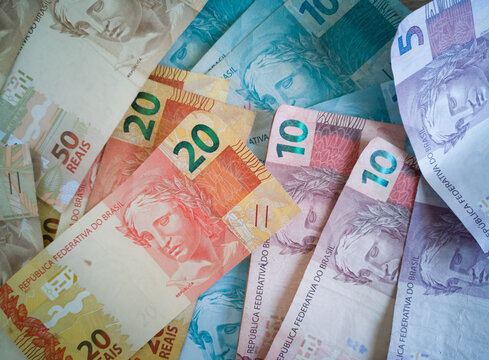 Brazilian money. Money bills of different values stacked. Finance concept.