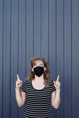 Portrait of a Girl in a protective mask, free space for text.