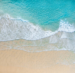Fototapeta na wymiar Aerial view of a beach with nice blue ocean, white sand and idyllic beach.