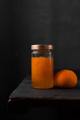 Preserved Tangerines with their juice in a glass jar, preserved citrus fruit