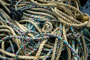 Fototapeta na wymiar Tangled colorfull fishing ropes, rope variety used for sailing, marine background