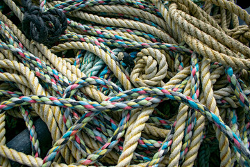Fototapeta na wymiar Tangled colorfull fishing ropes, rope variety used for sailing, marine background