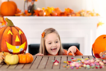 Fototapeta premium Kids in witch costume on Halloween trick or treat