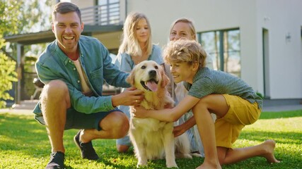 Smiling Beautiful Family of Four Posing with Happy Golden Retriever Dog on the Backyard Lawn. Idyllic Family Cuddling Loyal Pedigree Dog Outdoors in Summer House Backyard. Slow Motion Shot