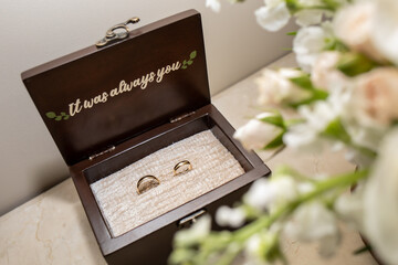 Golden Wedding rings in wooden chest.