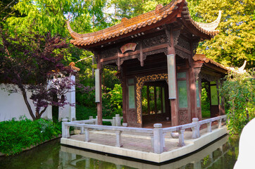 Fototapeta premium Beautiful building in asian style on water with plants.