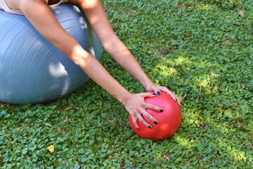 woman exercising with ball in park