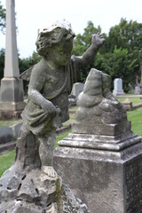 Fototapeta na wymiar Stone angel child on grave in Hollywood Cemetery, Richmond, Virginia