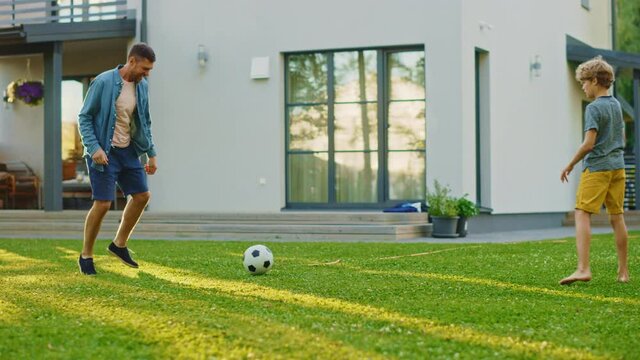 Happy Family of Four Playing Soccer, Passing Football to Each Other
