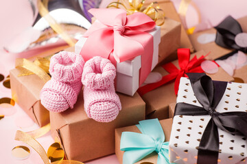 Pink baby shoes for little girl in gift box - concept of first step, birthday party, baby shower, anniversary. Gift and present box and little booties for cute baby girl, daughter