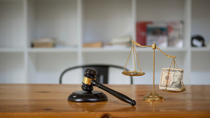 Judge hammer and gold scale with silver placed on the scale of justice concept law scale