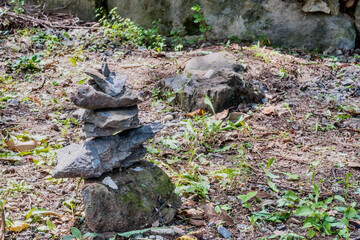 Fototapeta na wymiar Pebble stack with boulder in background