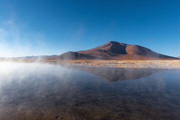 Hot springs of Polques at sunrise with hot steam, Uyuni salt flat region, Bolivia.