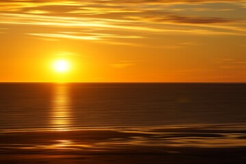 Awesome sunrise on the calm sea in orange gold yellow brown tones and soft clouds fine art photography