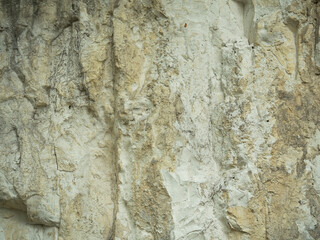 Texture of a chalk mountain close-up. Cracks, breaks, and water drips.