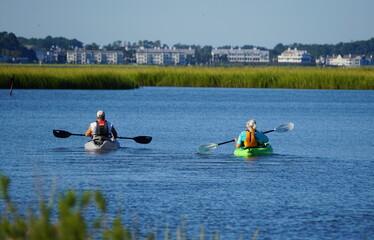 A couple on a kayak by the bay near Bethany Beach, Delaware, U.S - obrazy, fototapety, plakaty