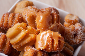 .Homemade mini churros with dulce de leche