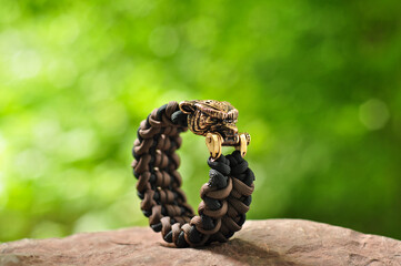 Braided paracord bracelet brown and black totem amulet bear's head on a stone