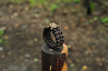 Braided paracord bracelet brown black totem amulet bear head stand back view