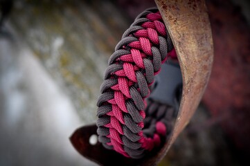 Braided paracord bracelet coffee garnet color on the hand with a lock fastex plastic
