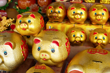 China town, Bangkok, Thailand, 16 April 2019, Golden piggy banks or coin keepers were sold in front of a street stall. Symbol of fertile and wealth and one of the twelve animals in Chinese calendar.