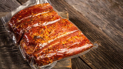 Vacuum packed meat on a wooden background. banner, menu, recipe, place for text