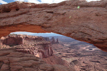 View of  Mesa Arch at island in the sky and landscape of Canyonlands National Park appearing under the arch in Utah, USA