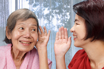 Asian seniors woman hearing loss , Hard of hearing try to talk with daughter.