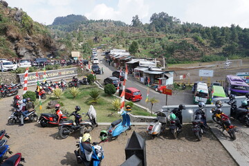 Wonosobo, 20 August 2020; Motorbikes and cars are parked at the tourist site of the Sikidang crater in Dieng, Wonosobo