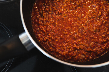 plant-based food,  vegan lentil and textured vegetable protein ragu sauce in pot on kitchen stovetop