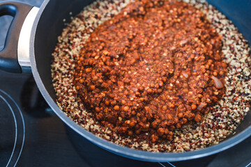 plant-based food, vegan lentil and textured vegetable protein ragu with quinoa in pot
