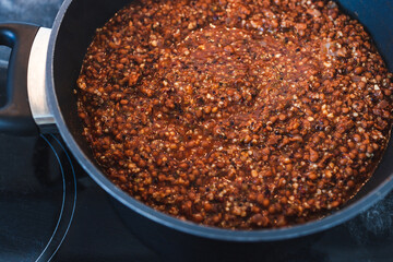 plant-based food, vegan lentil and textured vegetable protein ragu with quinoa in pot