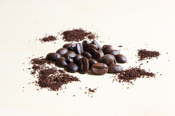 Coffee beans sugar and creamer on wood background