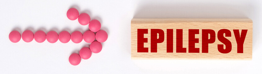 An arrow of pills points to a sign that says EPILEPSY