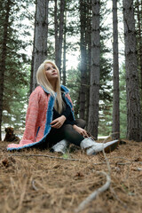 Beautiful asian woman relaxing in the middle of a pine forest.